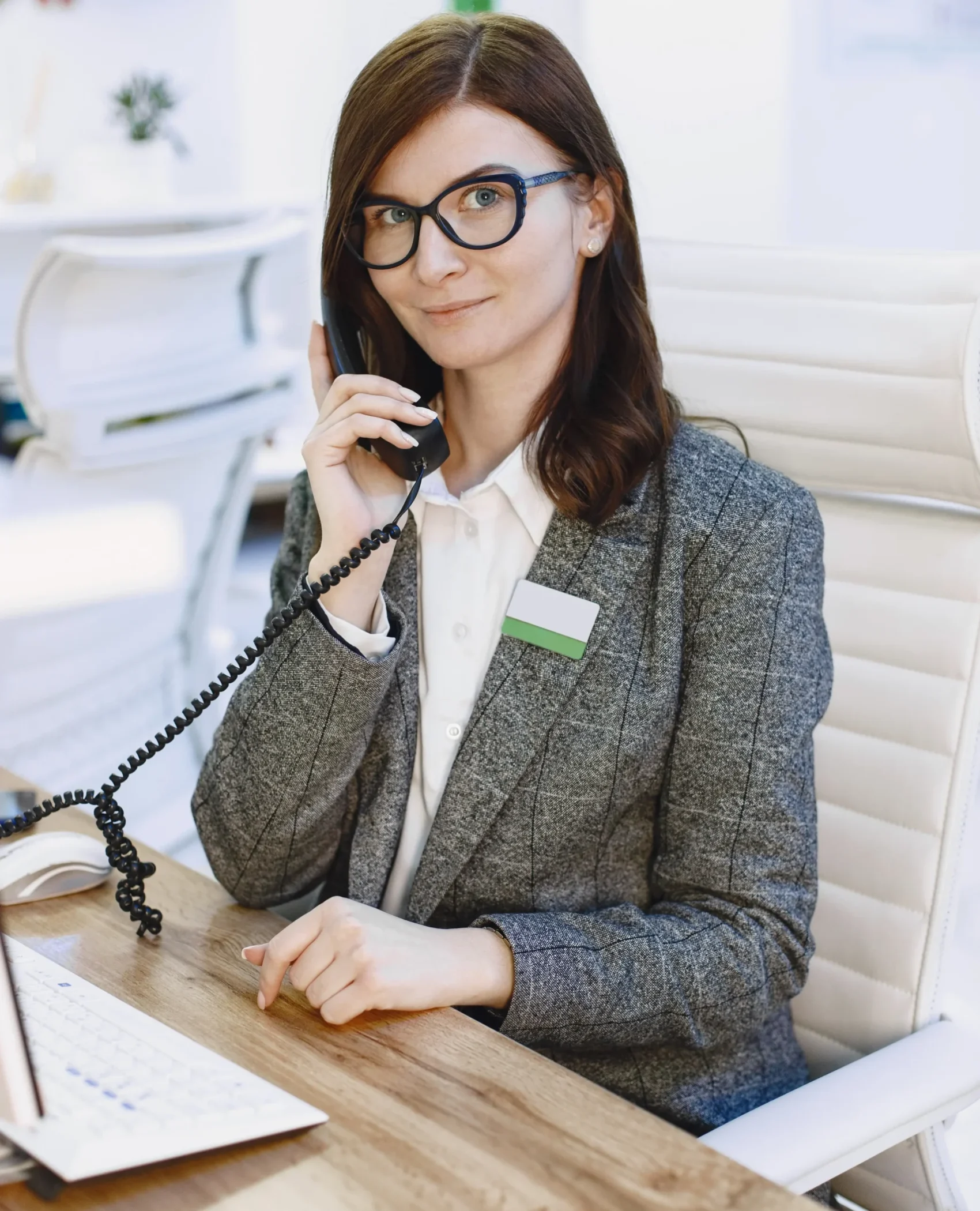 woman-administrator-visitor-reception-friendly-young-woman-suit-scaled